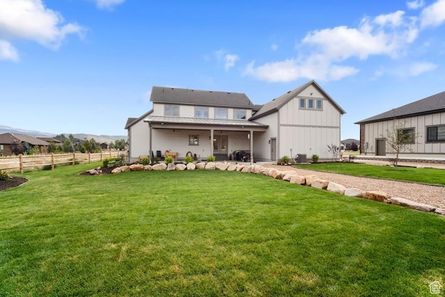 1806 S Summit Haven Dr Unit 1, Francis, UT 84036 - rear view of house with fence, a lawn, a standing seam roof, and metal roof