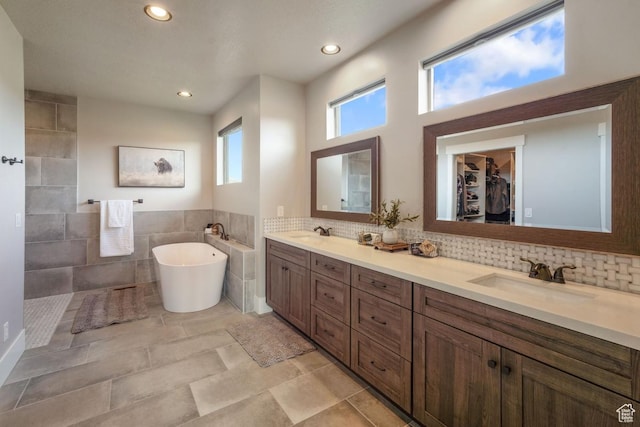 1806 S Summit Haven Dr Unit 1, Francis, UT 84036 - full bathroom featuring a freestanding bath, a sink, double vanity, and tile walls