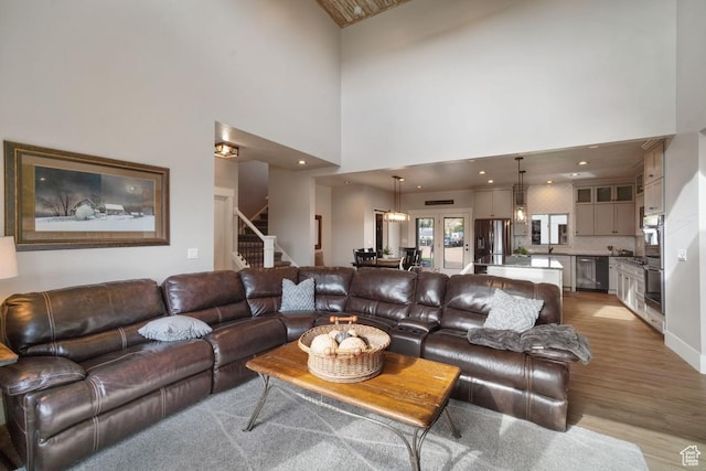 1806 S Summit Haven Dr Unit 1, Francis, UT 84036 - living area featuring high vaulted ceiling, stairs, and light wood-style floors