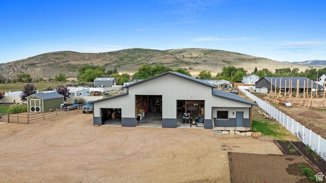 1806 S Summit Haven Dr Unit 1, Francis, UT 84036 - rear view of property featuring a detached garage, an outbuilding, fence, and a mountain view