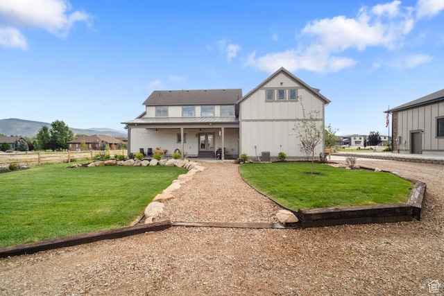 1806 S Summit Haven Dr Unit 1, Francis, UT 84036 - back of house with a mountain view, fence, ceiling fan, board and batten siding, and a yard