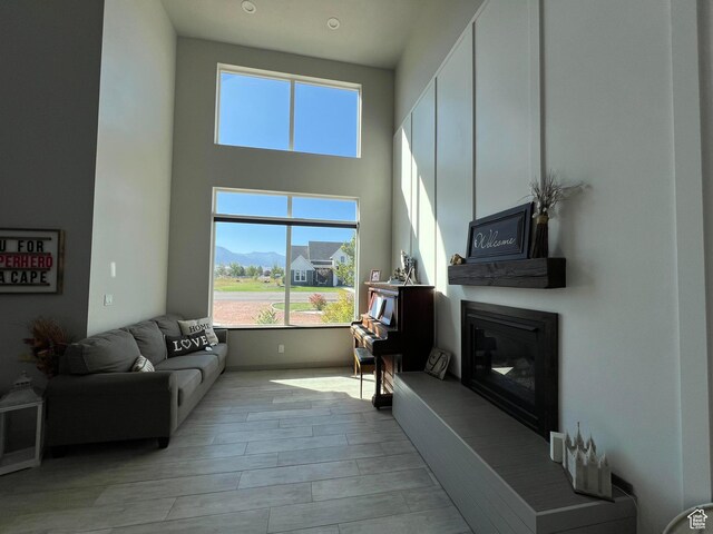472 W 2300 S Unit 18, Richfield, UT 84701 - living area with a glass covered fireplace, a towering ceiling, and wood finished floors