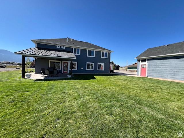 472 W 2300 S Unit 18, Richfield, UT 84701 - rear view of property featuring a yard, a patio, metal roof, and a standing seam roof