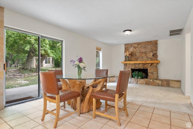 2328 W 300 N, Provo, UT 84601 - dining area with a stone fireplace, light tile patterned floors, a healthy amount of sunlight, and visible vents