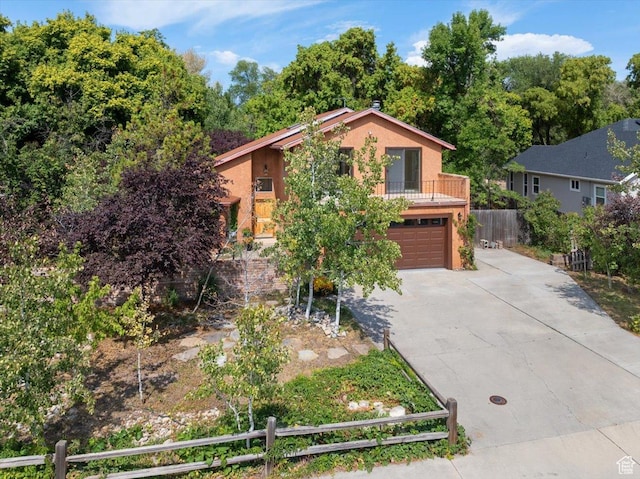 2328 W 300 N, Provo, UT 84601 - view of front of house with stucco siding, a garage, concrete driveway, and fence