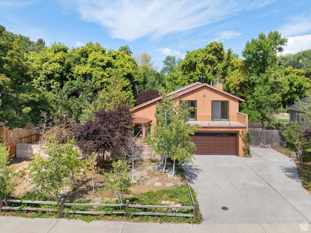 2328 W 300 N, Provo, UT 84601 - view of front of house featuring concrete driveway, fence, a garage, and stucco siding