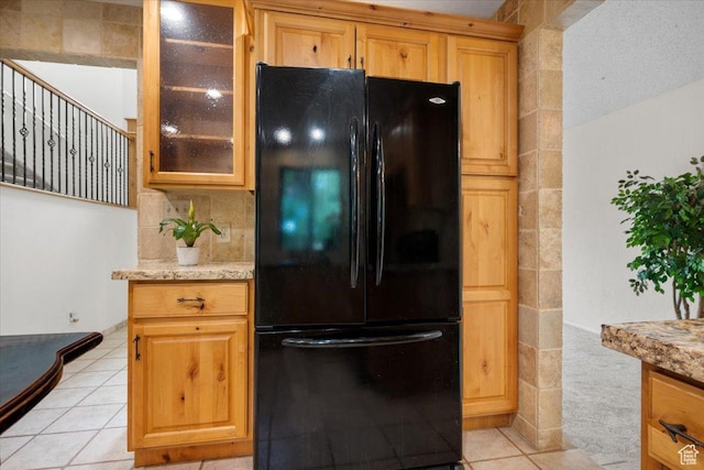 2328 W 300 N, Provo, UT 84601 - kitchen with light stone counters, glass insert cabinets, freestanding refrigerator, and light tile patterned flooring