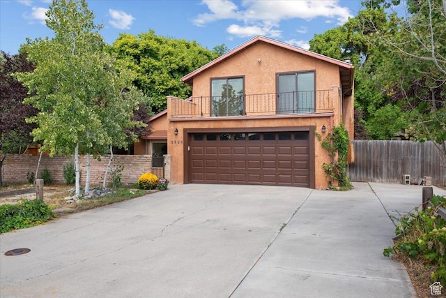 2328 W 300 N, Provo, UT 84601 - view of front facade featuring stucco siding, concrete driveway, an attached garage, and fence