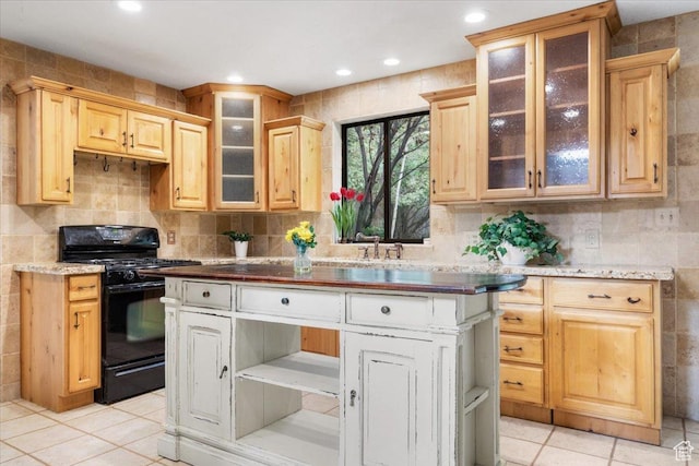 2328 W 300 N, Provo, UT 84601 - kitchen with a kitchen island, light brown cabinetry, black gas range, light tile patterned floors, and decorative backsplash