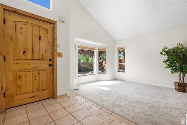2328 W 300 N, Provo, UT 84601 - entrance foyer with light tile patterned floors, visible vents, light carpet, and high vaulted ceiling