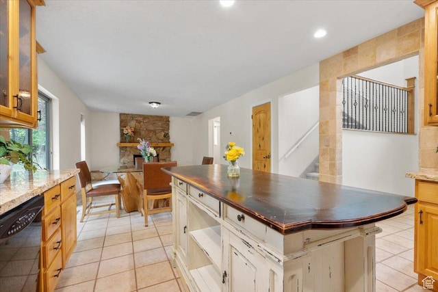 2328 W 300 N, Provo, UT 84601 - kitchen featuring a center island, dark stone counters, light tile patterned floors, glass insert cabinets, and dishwasher