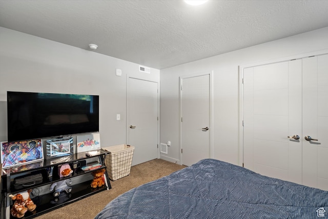 carpeted bedroom with a textured ceiling and visible vents