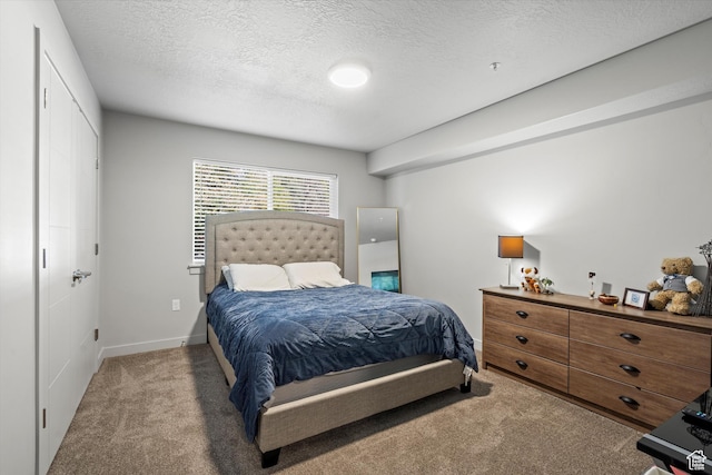 bedroom featuring a textured ceiling and carpet floors