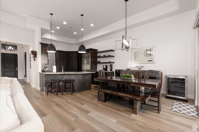 3318 S Red Rock Way, Hurricane, UT 84737 - dining area with light wood finished floors, baseboards, wine cooler, recessed lighting, and an inviting chandelier