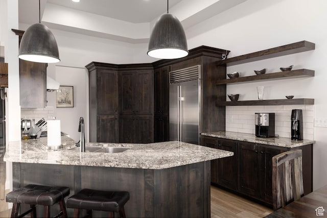 3318 S Red Rock Way, Hurricane, UT 84737 - kitchen with stainless steel built in fridge, open shelves, a sink, light stone countertops, and dark brown cabinetry