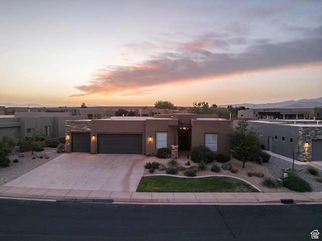 southwest-style home with stucco siding, concrete driveway, and a garage