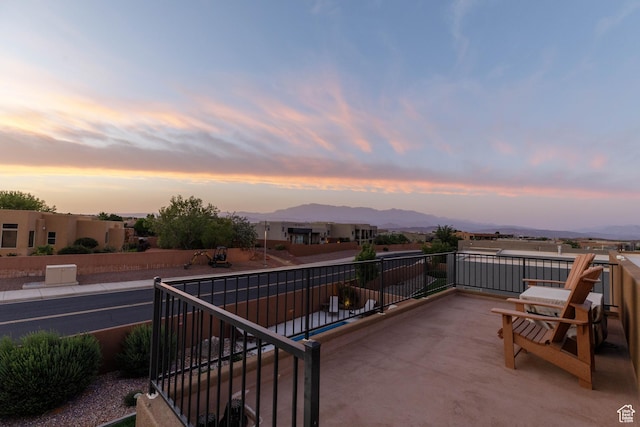 3318 S Red Rock Way, Hurricane, UT 84737 - patio terrace at dusk featuring a balcony and a mountain view