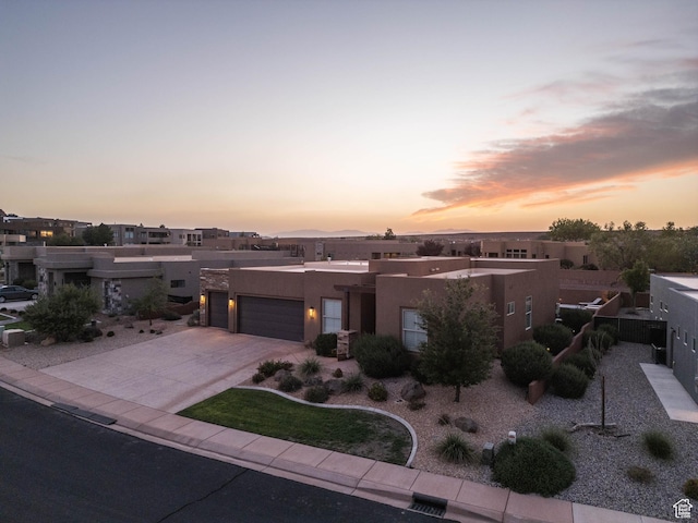 3318 S Red Rock Way, Hurricane, UT 84737 - pueblo-style home with stucco siding, driveway, and an attached garage