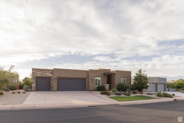 3318 S Red Rock Way, Hurricane, UT 84737 - southwest-style home with driveway, stone siding, an attached garage, and stucco siding
