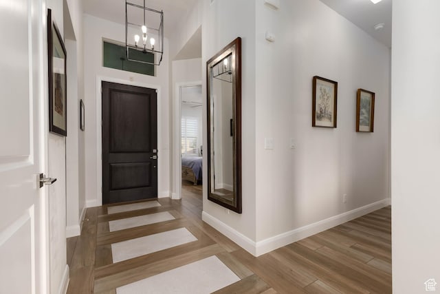 3318 S Red Rock Way, Hurricane, UT 84737 - entrance foyer featuring baseboards, a notable chandelier, and wood finished floors