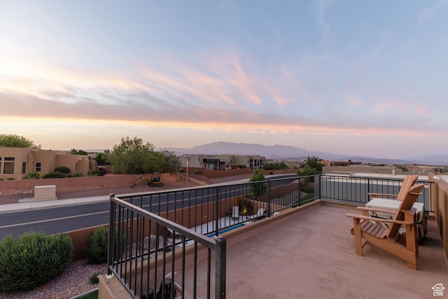 3318 S Red Rock Way, Hurricane, UT 84737 - patio terrace at dusk featuring a balcony and a mountain view
