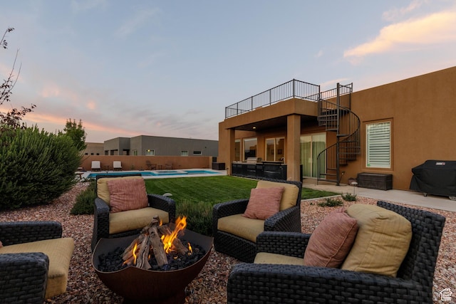 3318 S Red Rock Way, Hurricane, UT 84737 - exterior space featuring a patio, an outdoor fire pit, a fenced in pool, stairway, and stucco siding