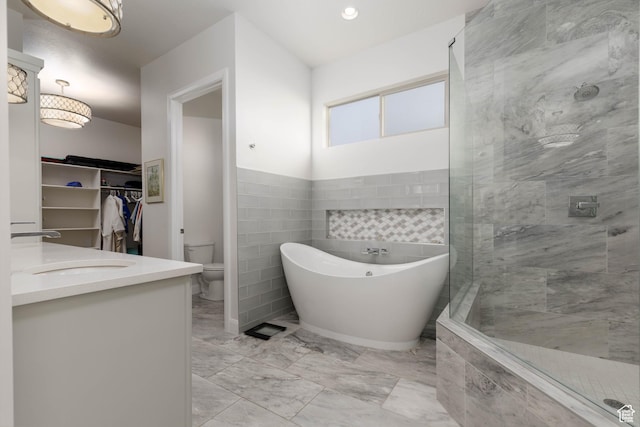 3318 S Red Rock Way, Hurricane, UT 84737 - full bathroom with a spacious closet, toilet, a shower stall, marble finish floor, and a freestanding bath