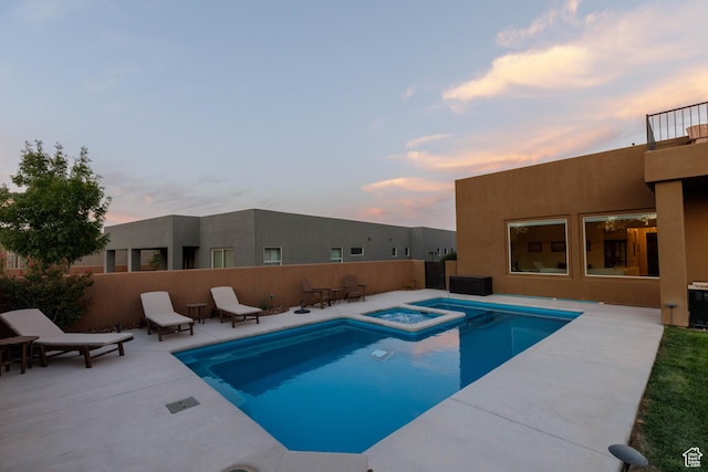 3318 S Red Rock Way, Hurricane, UT 84737 - pool at dusk with fence, an in ground hot tub, a patio, and a fenced in pool