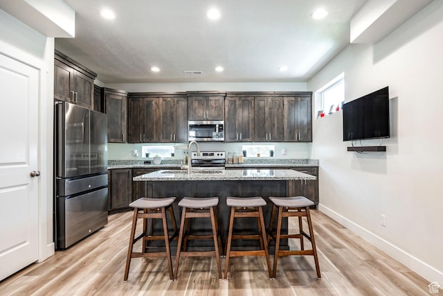 668 S 400 E, Clearfield, UT 84015 - kitchen with appliances with stainless steel finishes, dark brown cabinets, a sink, recessed lighting, and light wood-style floors