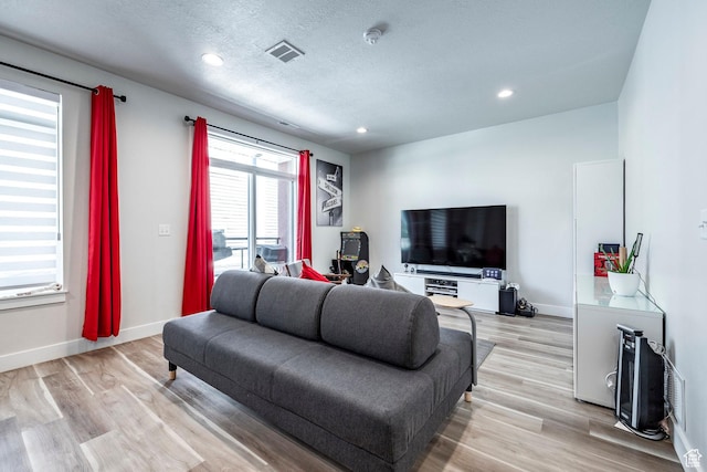 668 S 400 E, Clearfield, UT 84015 - living room featuring baseboards, recessed lighting, light wood-style floors, and a textured ceiling
