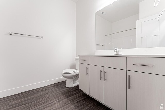 4718 W Neill Ln Unit Mm303, Riverton, UT 84096 - bathroom featuring toilet, vanity, wood finished floors, baseboards, and visible vents