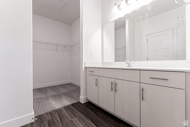 4718 W Neill Ln Unit Mm303, Riverton, UT 84096 - bathroom featuring baseboards, wood finished floors, a spacious closet, and vanity