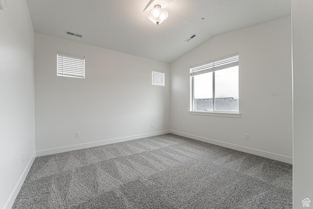 4718 W Neill Ln Unit Mm303, Riverton, UT 84096 - carpeted spare room with baseboards, visible vents, and vaulted ceiling