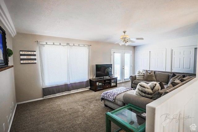 carpeted living room with baseboards, a ceiling fan, and a textured ceiling
