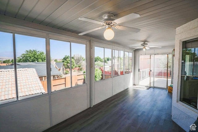unfurnished sunroom with ceiling fan and a healthy amount of sunlight