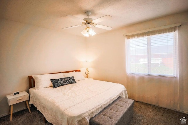 bedroom with a ceiling fan and carpet
