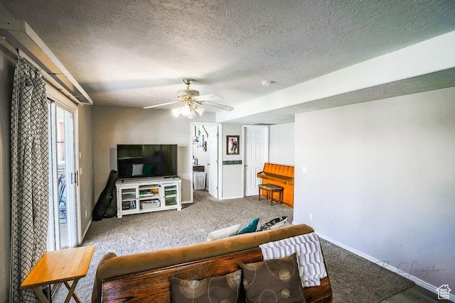 carpeted living area featuring a ceiling fan, a textured ceiling, and baseboards