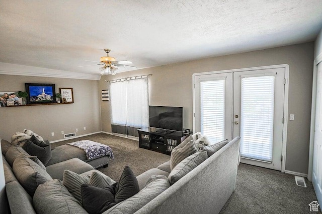 carpeted living area featuring baseboards, visible vents, and ceiling fan