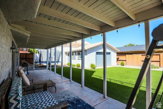 view of patio / terrace featuring an outdoor structure, a fenced backyard, and a trampoline