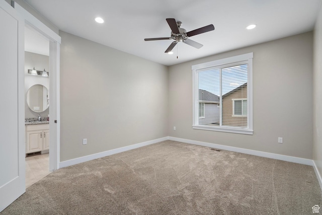 unfurnished room with light carpet, baseboards, and ceiling fan