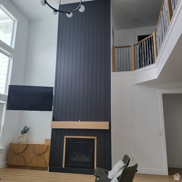 2580 E 279 S, Spanish Fork, UT 84660 - living room featuring a towering ceiling, a large fireplace, and hardwood / wood-style flooring