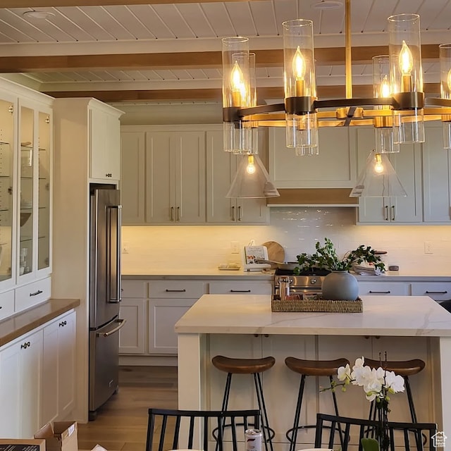 2580 E 279 S, Spanish Fork, UT 84660 - kitchen with hanging light fixtures, a kitchen bar, high quality fridge, and light hardwood / wood-style flooring