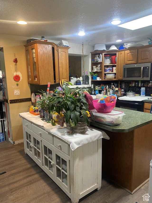 4310 S 2675 W, Roy, UT 84067 - kitchen featuring black range with electric stovetop, a textured ceiling, dark hardwood / wood-style flooring, and a kitchen island