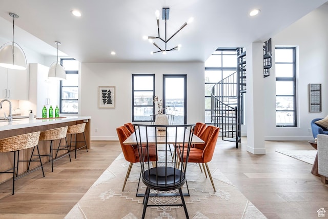 656 N E Capitol St, Salt Lake City, UT 84103 - dining space with light wood-type flooring, a chandelier, recessed lighting, and stairs