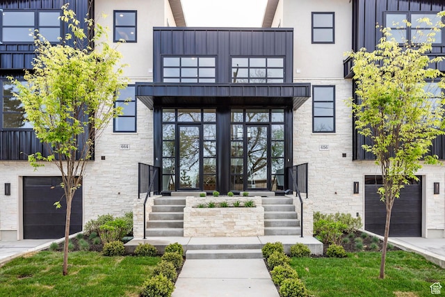 656 N E Capitol St, Salt Lake City, UT 84103 - view of exterior entry with a balcony, stone siding, stucco siding, and a garage