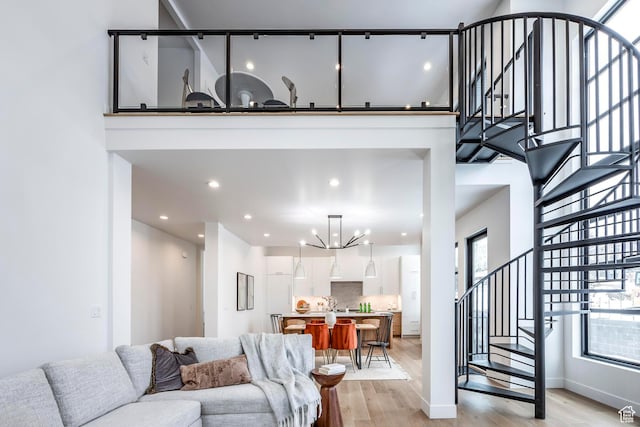 656 N E Capitol St, Salt Lake City, UT 84103 - living area featuring stairs, light wood-style flooring, a chandelier, and recessed lighting