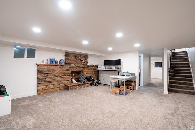 living room with carpet and a fireplace