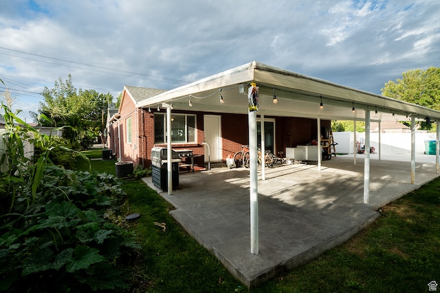 back of house with cooling unit and a patio area
