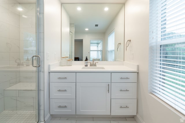 bathroom featuring vanity, tile patterned flooring, and an enclosed shower
