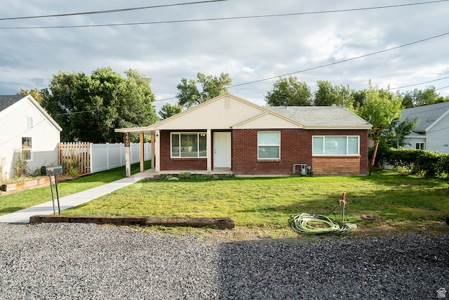 ranch-style home with a front lawn
